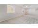 Bright bedroom featuring neutral carpet, white walls, a ceiling fan, and multiple windows at 5641 Vassar Meadow St, Las Vegas, NV 89148