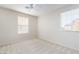 Light-filled bedroom with neutral walls, carpet, ceiling fan, and bright windows at 5641 Vassar Meadow St, Las Vegas, NV 89148