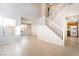 Bright entryway featuring tile floors, staircase and views into the kitchen and living spaces at 5641 Vassar Meadow St, Las Vegas, NV 89148