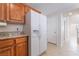 Bright kitchen boasts granite counters, wood cabinets, and white appliances at 5641 Vassar Meadow St, Las Vegas, NV 89148