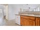 Kitchen features wood cabinetry, granite counters, and white dishwasher at 5641 Vassar Meadow St, Las Vegas, NV 89148