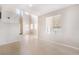 Bright living room with soaring ceilings, tile floors, and natural light from multiple windows at 5641 Vassar Meadow St, Las Vegas, NV 89148