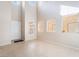 Bright living room with high ceilings, tile floors, and large windows for ample natural light at 5641 Vassar Meadow St, Las Vegas, NV 89148