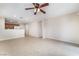Open living room features a ceiling fan and views into the kitchen at 5641 Vassar Meadow St, Las Vegas, NV 89148