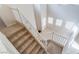 Carpeted staircase featuring white wooden railing and vaulted ceilings at 5641 Vassar Meadow St, Las Vegas, NV 89148