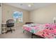Cozy bedroom with a large window, plush carpet, and a ceiling fan at 5667 Foxglove Field St, Las Vegas, NV 89130