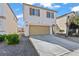 Charming two-story home showcasing a two-car garage, tidy landscaping, and a welcoming entryway at 5667 Foxglove Field St, Las Vegas, NV 89130