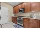 The kitchen features stainless steel appliances, granite countertops, and wooden cabinets at 5667 Foxglove Field St, Las Vegas, NV 89130