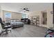 Spacious main bedroom with ceiling fan, wood-look floors, and comfortable seating at 5667 Foxglove Field St, Las Vegas, NV 89130