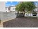 Backyard features a privacy wall, a tree, decorative rock ground cover, and a seating area at 5967 Aimless St, Henderson, NV 89011