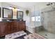 Bathroom with dual vanity, soaking tub, shower with glass enclosure and sleek design at 5967 Aimless St, Henderson, NV 89011
