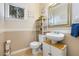 Well-lit bathroom with a modern sink, decorative mirror and shelving for storage and decor at 5967 Aimless St, Henderson, NV 89011