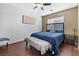 Comfortable bedroom featuring ceiling fan, bedside tables and a cozy bench at the foot of the bed at 5967 Aimless St, Henderson, NV 89011
