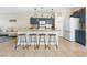 Well-equipped kitchen featuring granite countertops, stainless steel appliances, and stylish breakfast bar at 5967 Aimless St, Henderson, NV 89011