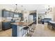 The kitchen features a granite-topped breakfast bar, abundant cabinetry, and modern stainless appliances at 5967 Aimless St, Henderson, NV 89011