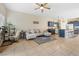Inviting living room with modern decor, desk, comfortable seating, and an adjacent kitchen area at 5967 Aimless St, Henderson, NV 89011
