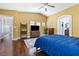 Spacious main bedroom features wood floors, vaulted ceiling, tv, and walk through to bathroom at 5967 Aimless St, Henderson, NV 89011