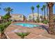 Relaxing community pool surrounded by palm trees and well-maintained landscaping at 6170 E Sahara Ave # 1076, Las Vegas, NV 89142