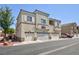 Exterior shot of condo building with garage, balconies, and well-kept landscaping at 6170 E Sahara Ave # 1076, Las Vegas, NV 89142