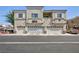 View of the condo building with garages, balconies, and ample parking spaces at 6170 E Sahara Ave # 1076, Las Vegas, NV 89142