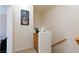 Upper hallway with wooden handrail, small display cabinet, and carpeted floors at 6170 E Sahara Ave # 1076, Las Vegas, NV 89142