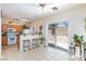 Bright kitchen area with tile floors, breakfast bar, and sliding glass doors to the backyard at 6170 E Sahara Ave # 1076, Las Vegas, NV 89142