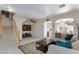 Bright and airy living room with staircase, decorative archways, and a comfortable seating area at 6170 E Sahara Ave # 1076, Las Vegas, NV 89142
