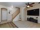 Spacious living room featuring a ceiling fan, a large television, and an open staircase at 6170 E Sahara Ave # 1076, Las Vegas, NV 89142