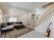 Bright living room with a comfortable sectional sofa, stylish rug, and staircase to the second floor at 6170 E Sahara Ave # 1076, Las Vegas, NV 89142