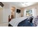 Comfortable bedroom with a wooden bed frame, view of the ensuite bathroom, and bright window at 6170 E Sahara Ave # 1076, Las Vegas, NV 89142