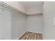 Walk-in closet with neutral walls and flooring, equipped with closet rods for optimal storage at 6953 Graceful Cloud, Henderson, NV 89011