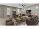Cozy living room with neutral tones, large windows, and a decorative rug at 6953 Graceful Cloud, Henderson, NV 89011