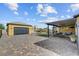 Beautiful backyard showcasing a detached garage, covered patio, and ample paved space at 7036 Winstar St, Las Vegas, NV 89131