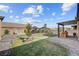 Beautiful backyard featuring lush grass, paver pathways, a gazebo, and an outdoor kitchen area at 7036 Winstar St, Las Vegas, NV 89131