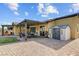 Charming backyard with a covered patio, storage shed, and spacious paved area for outdoor living at 7036 Winstar St, Las Vegas, NV 89131