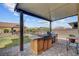 Outdoor kitchen and barbeque under covered patio at 7036 Winstar St, Las Vegas, NV 89131