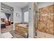 Bathroom featuring a soaking tub with custom tile surround and glass door shower at 7036 Winstar St, Las Vegas, NV 89131