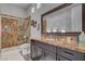 Bathroom features a shower with glass door and granite countertops at 7036 Winstar St, Las Vegas, NV 89131