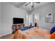 Comfortable bedroom featuring a ceiling fan, TV on stand, and view into ensuite bath at 7036 Winstar St, Las Vegas, NV 89131