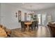 Elegant dining room showcasing wood floors, decorative lighting, and a table with comfortable seating at 7036 Winstar St, Las Vegas, NV 89131