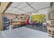 View of the garage showcasing organized storage, tools, and wall art with a smooth, finished floor at 7036 Winstar St, Las Vegas, NV 89131