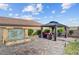 Relaxing gazebo with comfortable seating, surrounded by lush landscaping and a decorative water feature at 7036 Winstar St, Las Vegas, NV 89131
