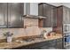 Gourmet kitchen with granite countertops, stainless steel appliances, and a modern range hood at 7036 Winstar St, Las Vegas, NV 89131