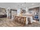 Spacious kitchen featuring a large island, stainless steel appliances and dark wood cabinets at 7036 Winstar St, Las Vegas, NV 89131