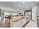 Open-concept kitchen features a large island with seating and stainless steel appliances at 7036 Winstar St, Las Vegas, NV 89131