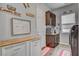 Functional laundry area showcases organized storage, a utility sink, modern appliances, and stylish decor at 7036 Winstar St, Las Vegas, NV 89131