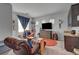 Comfortable living room with stylish chair, dark cabinets, and bright windows at 7036 Winstar St, Las Vegas, NV 89131