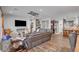 Open-concept living room featuring hardwood floors, a decorative ceiling fan, and a glimpse into the modern kitchen at 7036 Winstar St, Las Vegas, NV 89131