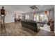 Spacious living room with wood-look tile floors, and sliding glass doors to outdoor living space at 7036 Winstar St, Las Vegas, NV 89131