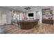 Inviting living room featuring a large sectional sofa, a decorative ceiling fan, and patio access at 7036 Winstar St, Las Vegas, NV 89131